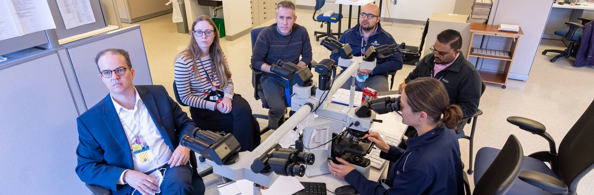 Neuropathology faculty using microscope
