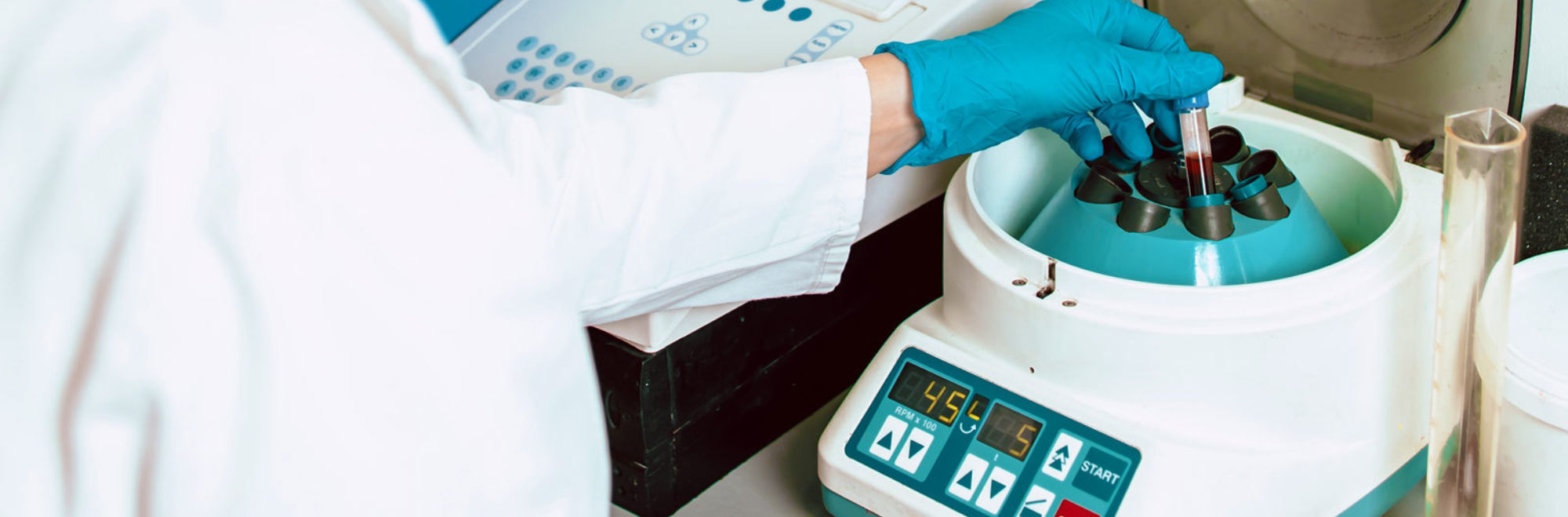 Technician using centrifuge