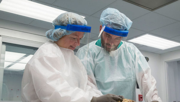 Jody Hooper performing autopsy with assistant