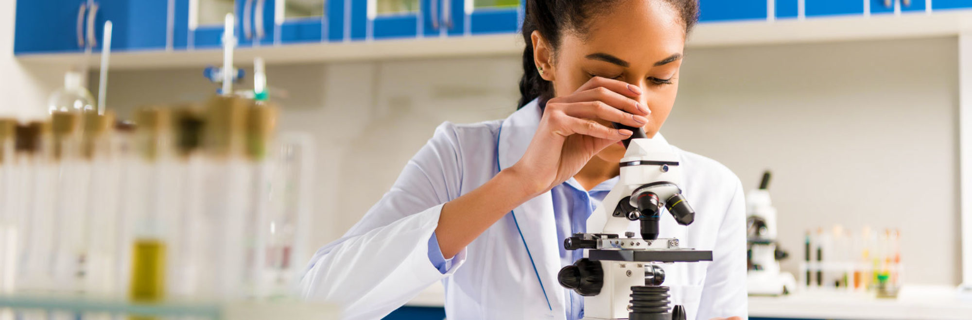 Scientist using microscope